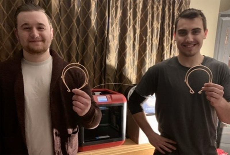 Dalton Butz and Gabriel Moyer show off their 3D semi-circle for face shields.