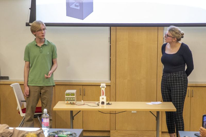 Female and male student present automatic toothpaste dispenser