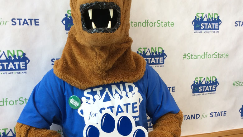 The Nittany Lion mascot wearing a Stand for State T-shirt