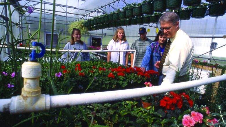 Dr. Sanford and student in greenhouse