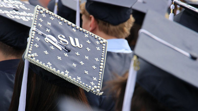 Penn State Berks student shows off their cap during graduation.