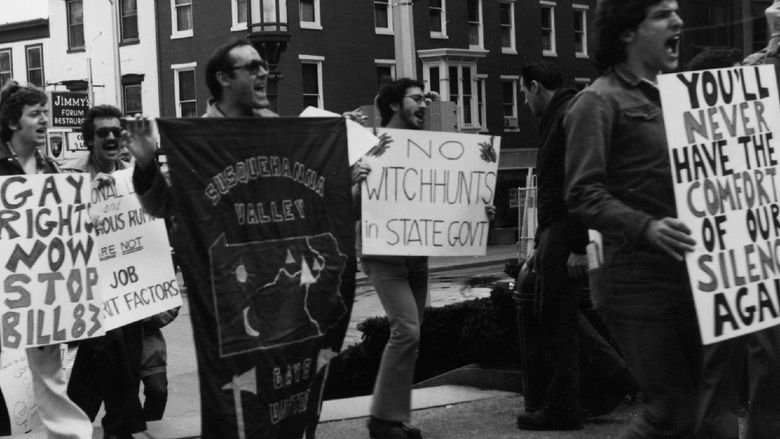 a black and white photo of protesters advocating for LGBTQI+ rights