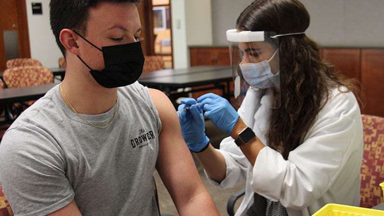 Student participate in vaccination clinic held on campus.