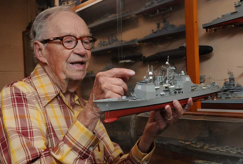 Ed Wiswesser is pictured with a model train.