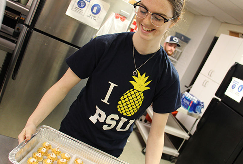 Student preparing food at Opportunity House