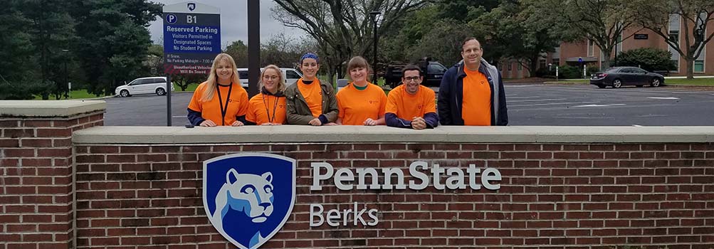 Students stand behing the Penn State Berks sign near the Luerssen parking lot