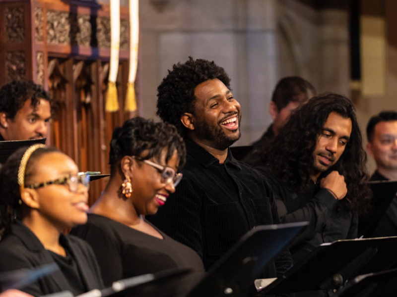 Several members of a choir singing joyously together