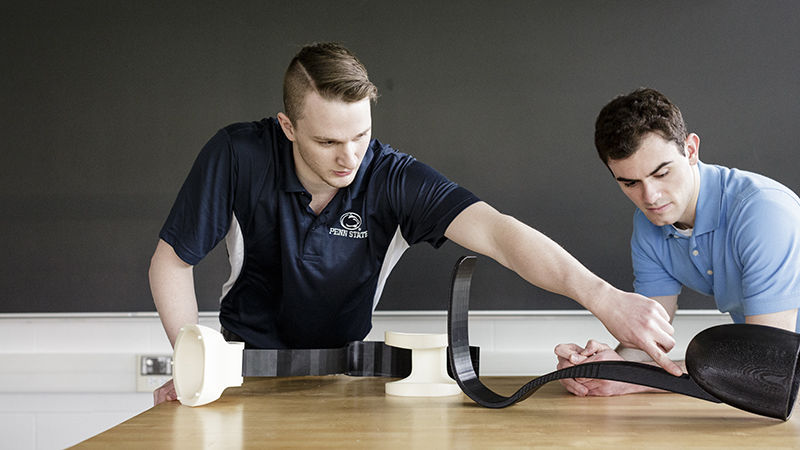 Miller (left) and Bleicher display the leg prosthetic, which was entered in the ASME IAM 3D Challenge.