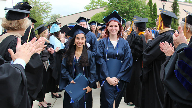Two student marshals lead the graduating class out of Beaver Community Center
