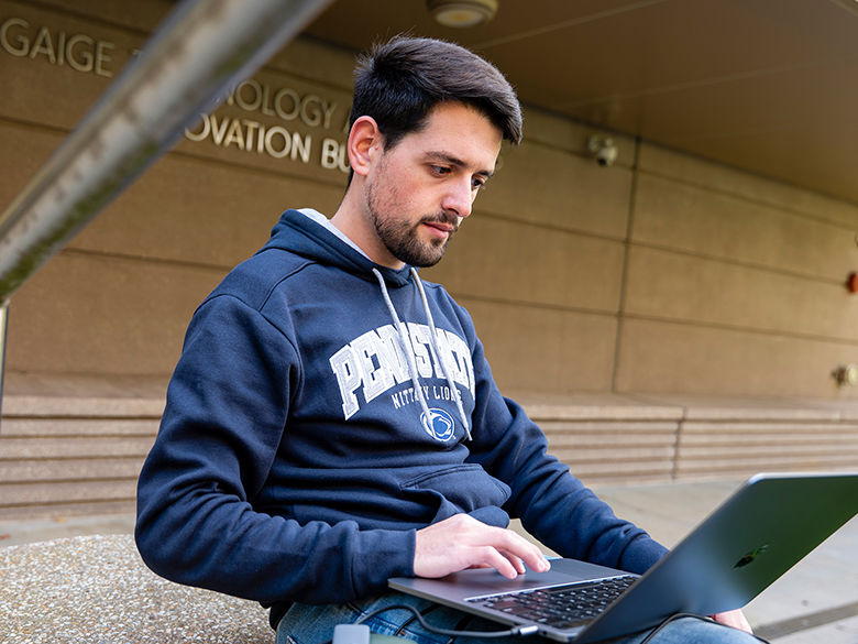 Male Penn State Berks student working on a laptop