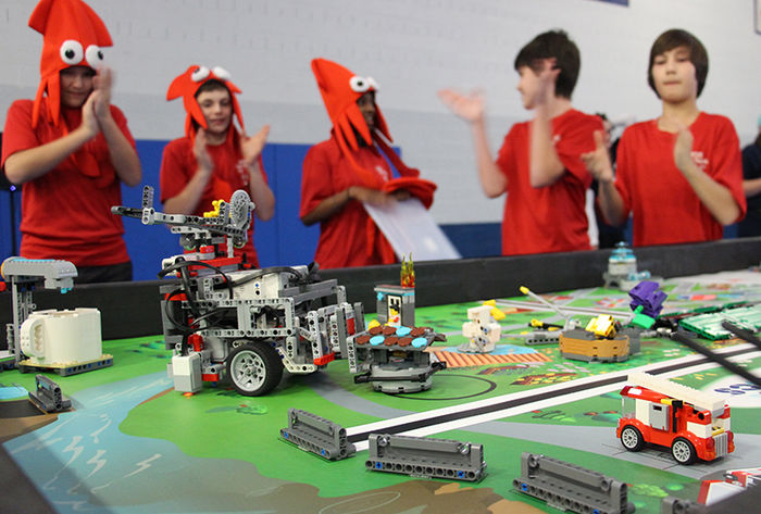A team cheers on their robot during the competition rounds of the FIRST Lego League event