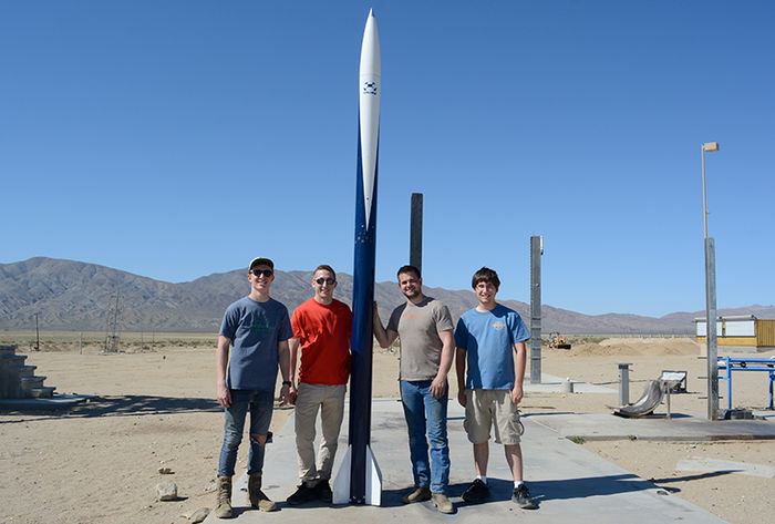 Kale Odhner and his fellow Penn State Berks students pose with their rocket