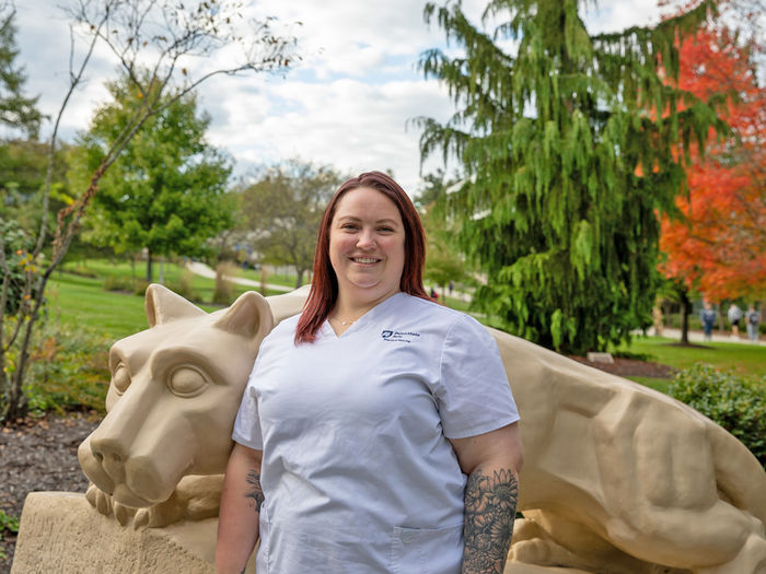Photo of Emiley Witman in front of Penn State Berks lion shrine