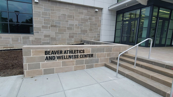The entrance to the Beaver Athletic and Wellness Center, with the name displayed on a brick wall