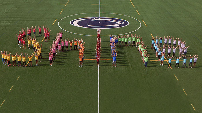 The Berks Orientation Team forming the word 'Shine' on the athletic field