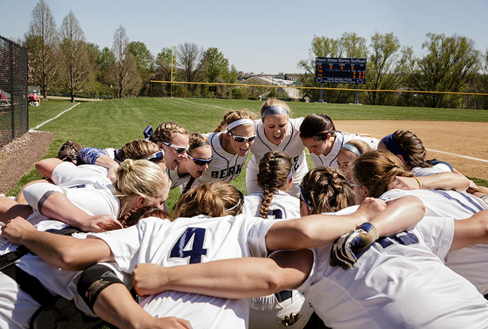 The softball team huddles together before a game