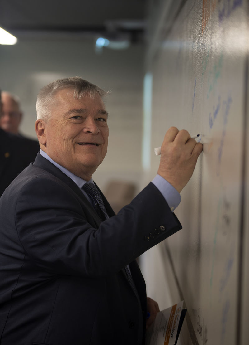 Dr. Eric Barron signs the Fayette LaunchBox wall of fame.