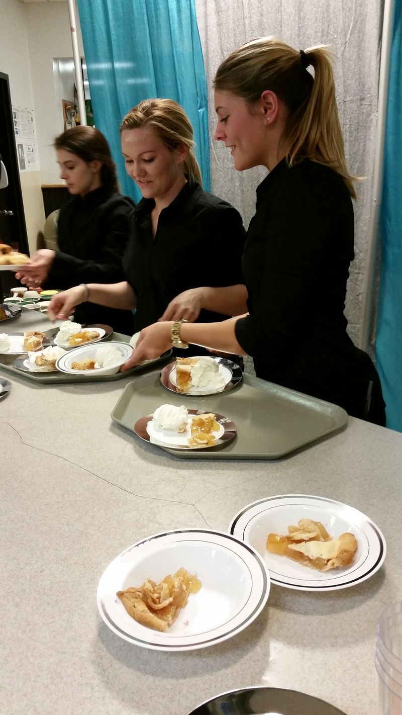 HRIM students serving dessert