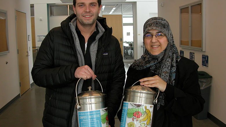 Senior Dakota Schoppe (left) and Dr. Mahsa Kazempour are pictured with the composting containers now found across campus. 