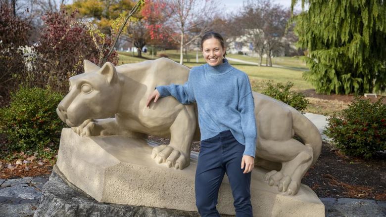 Diana Stoltzfus standing by the lion shrine