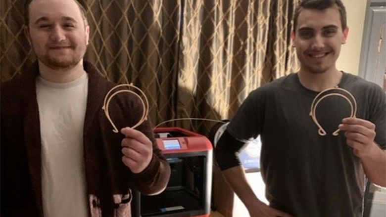 Dalton Butz and Gabriel Moyer show off their 3D semi-circle for face shields.
