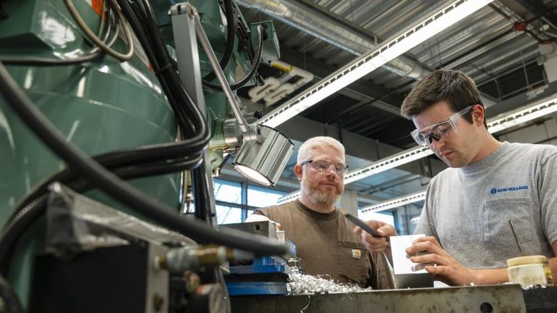 Student and instructor working at MILL machine