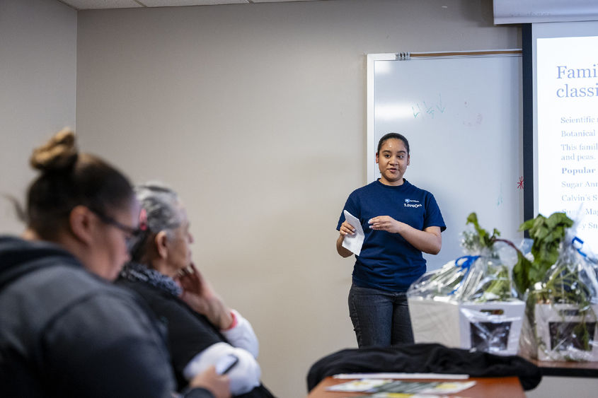 Student presents vegetable research to community members