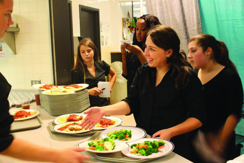 students serving dinner