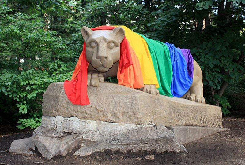 A rainbow pride flag over the Nittany Lion.