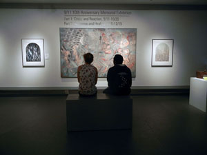 Two people viewing artwork in gallery