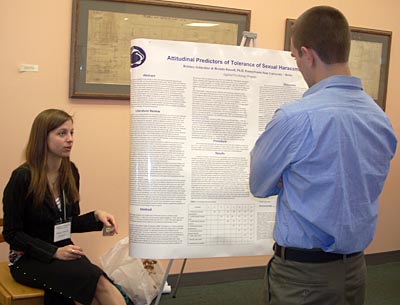 Female student presenting her research poster