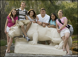 students at Nittany Lion statue